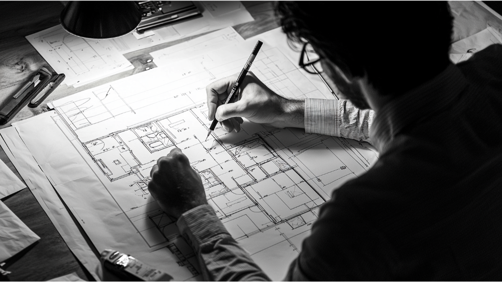 A man drafting home plans